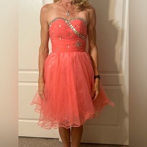 New without tags. Never worn. Adorable coral homecoming, prom, semi-formal.